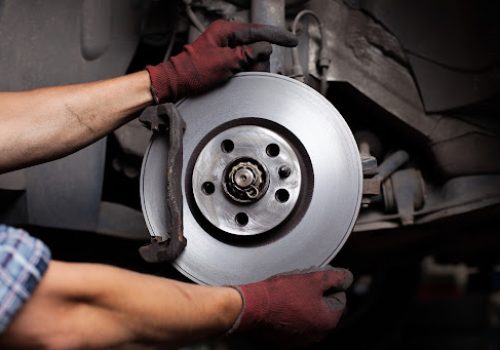 Car mechanic Repairing brakes on car